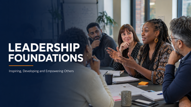 A diverse group of adult participants discussing leadership and personal development during a professional training session.